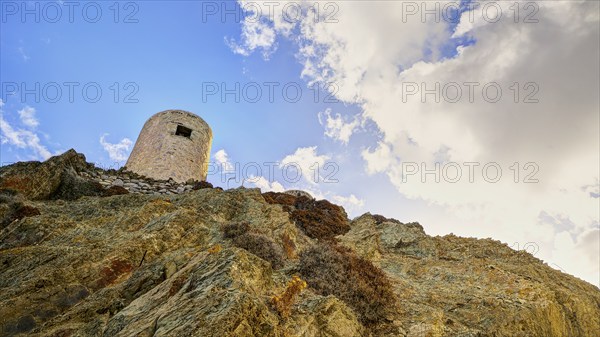 Ruin of a windmill, Old tower on a rocky hill in front of a cloudy sky, Colourful mountain village, Morning light, Olymbos, Karpathos, Dodecanese, Greek Islands, Greece, Europe