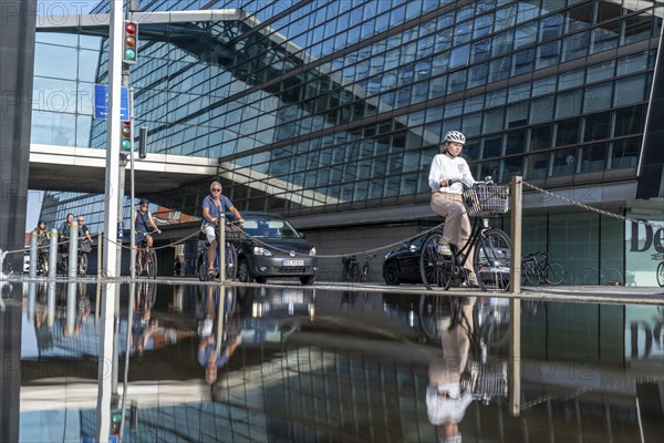 Cyclists on the cycle path on Christians Brygge Street, at the Black Diamond, Danish Royal Library, Copenhagen is considered the cycling capital of the world, 45 % of the population travel by bike, Denmark, Europe