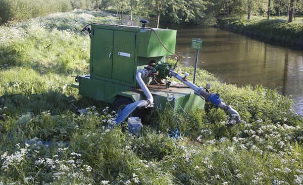 Irrigation water pump machinery on the River Stour at Bures, Essex, England, United Kingdom, Europe