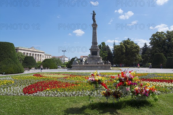 A sunny park with a large monument surrounded by colourful flowerbeds and green trees, Municipal Courthouse, Monument to Freedom, Russe, Rousse, Ruse, Pyce, Bulgaria, Europe
