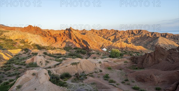 Erosion landscape of red and yellow sandstone, rock formations at sunrise, Skazka Canyon, fairytale gorge, Tosor, Kyrgyzstan, Asia