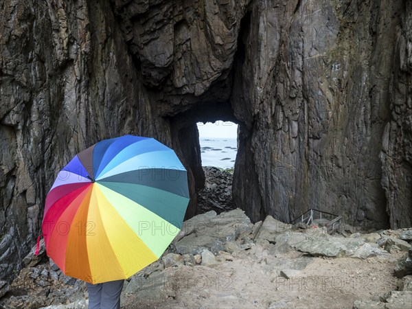 Woman with colorful umbrella, Torghatten cave, Torghatten mountain, Brønnøysund, Norway, Europe