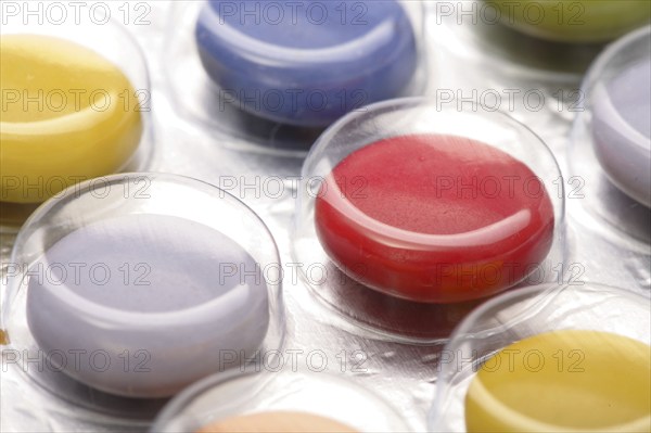 Colourful tablets packed in plastic, tablet addiction, drug addiction, studio