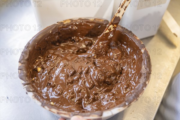 Container with liquid dark chocolate and a spoon, Burch Schokolade production, Haselstaller Hof, Gechingen, Germany, Europe