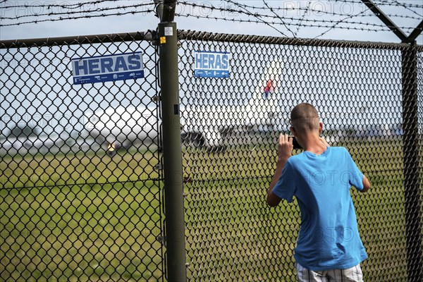 Amsterdam Schiphol Airport, Jet on the taxiway, to the Polderbaan runway, aeroplane spotter taking photos at the fence, Amsterdam, Netherlands