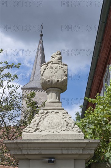 Vase attachment on a courtyard gate, 1774, behind the tower of the parish church of St John the Baptist, Hüttenheim, Lower Franconia, Bavaria, Germany, Europe