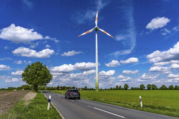 Wind turbine, wind energy plant from the manufacturer Enercon, blue sky with many white clouds, near Schermbeck, country road, Bestener Straße, North Rhine-Westphalia, Germany, Europe