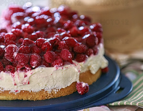 A fresh, creamy raspberry tart with fresh raspberries and cream