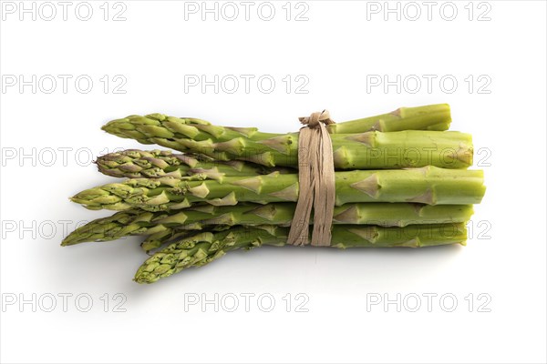 Bunch of fresh green asparagus isolated on white background. Side view, close up. harvest, healthy, vegan food, concept, minimalism