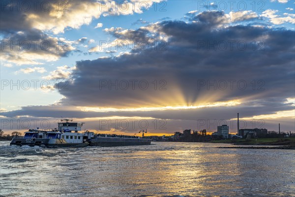 Cargo ship on the Rhine between Duisburg and Krefeld, dramatic sunset, North Rhine-Westphalia, Germany, Europe
