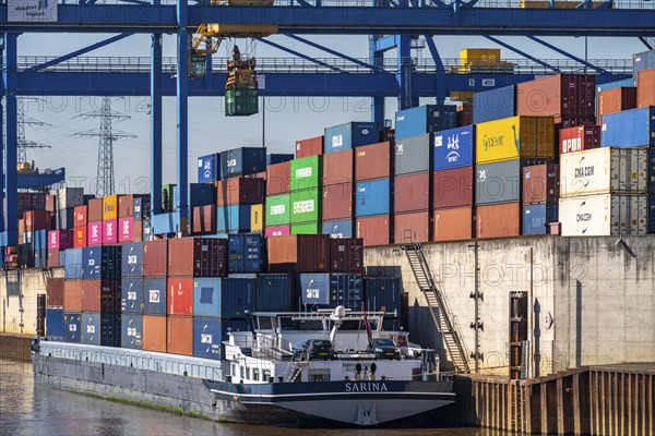 Container cargo ship in the harbour basin of the Logport, gantry cranes in the Container Handling Centre, Trimodal Container Terminal, in the Logport in Duisburg-Rheinhausen, cargo ship, Duisburg, North Rhine-Westphalia, Germany, Europe
