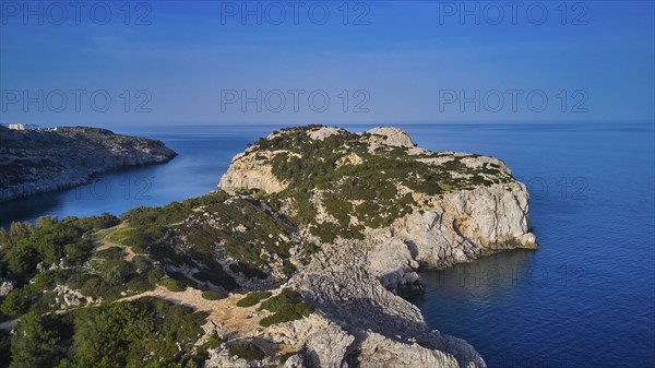 Drone shot, panorama of the rocky coast with steep cliffs, calm sea and a bright blue sky, Anthony Quinn Bay, Vagies Bay, Rhodes, Dodecanese, Greek Islands, Greece, Europe