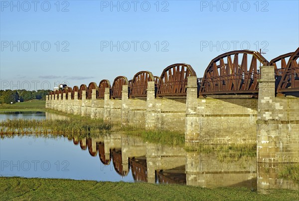 Close-up of stone bridge pillars and the calm water below reflecting the bridge on a clear day, Elbe, Skywalk, Dömitzer railway bridge, Langendorf, Wendland, Lower Saxony, Germany, Europe