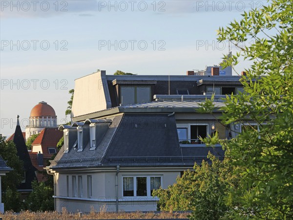 Above the rooftops of Leipzig: View of the dome of the Wünschmannhaus and Uniriese. Saxony, Germany, Europe