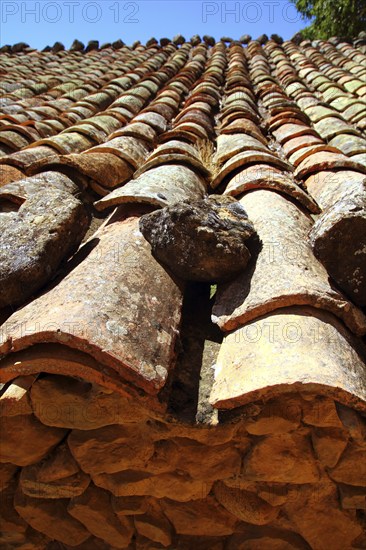 Clay roof tiles old aged arabic style in Spain perspective