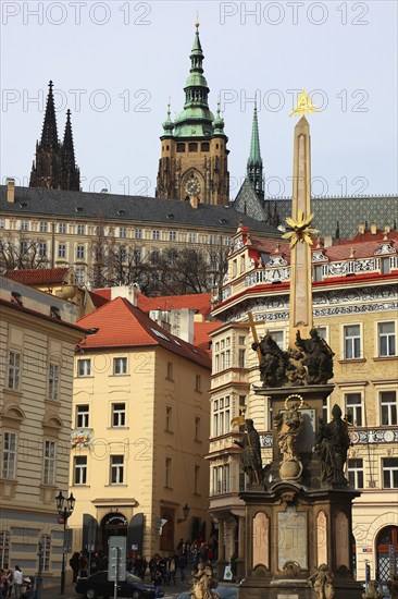 View of St Vitus Cathedral and the castle complex from Lesser Town Square with the Holy Trinity Column, Prague, Czech Republic, Europe