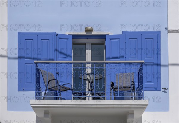 Balcony on a white house, blue door and window shutters, Symi Island, Dodecanese, Greek Islands, Greece, Europe