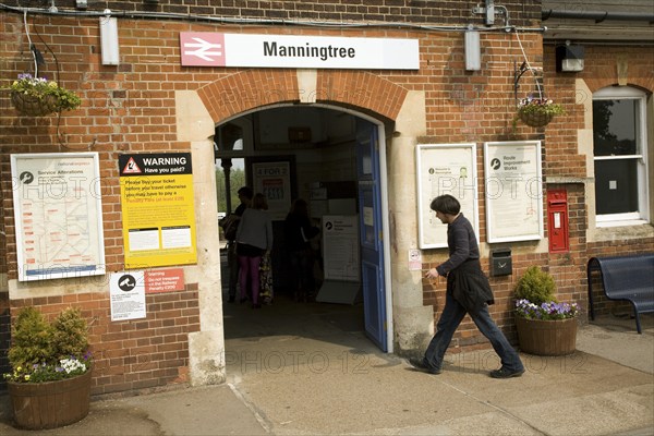 Man walks into Manningtree station entrance, Essex, England, United Kingdom, Europe