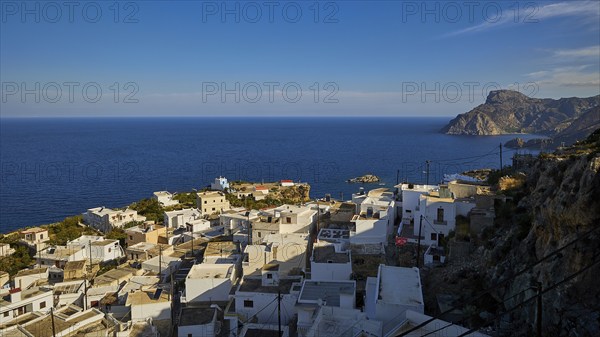 View of a coastal village with whitewashed houses and the sea in the background, Mesochori village, west coast, Karpathos, Dodecanese, Greek Islands, Greece, Europe