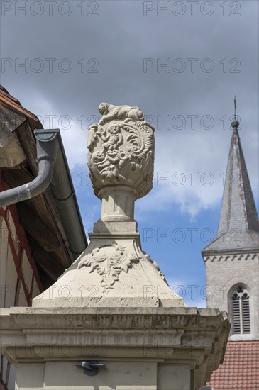 Vase attachment on a courtyard gate, 1774, behind the tower of the parish church of St John the Baptist, Hüttenheim, Lower Franconia, Bavaria, Germany, Europe