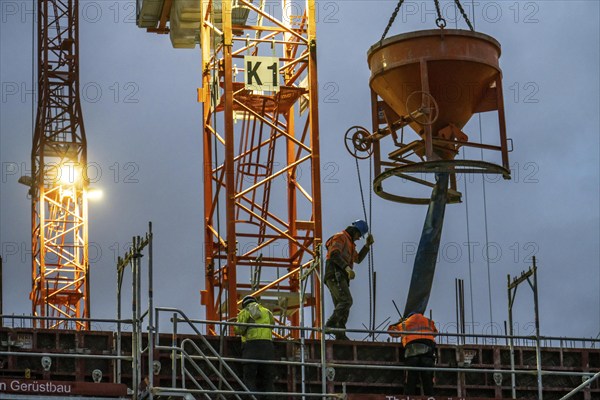 Concrete work, at dusk, on a large construction site building a residential and commercial complex, North Rhine-Westphalia, Germany, Europe