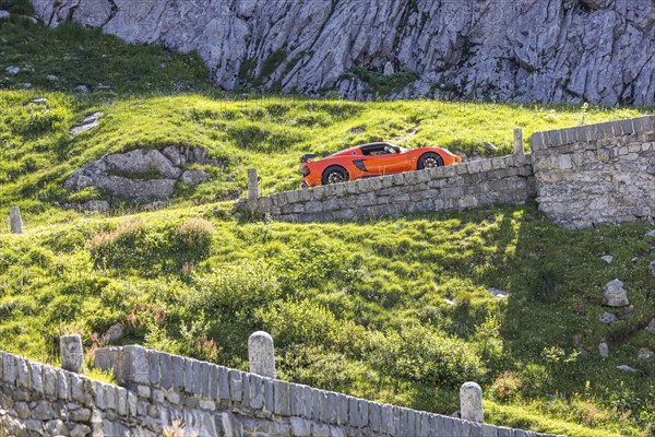 La Tremola, the world-famous serpentine road through the Val Tremolo, Switzerland's longest road monument with 24 hairpin bends. A popular leisure activity for owners of sports cars or vintage cars is the tour over the winding Alpine pass. Airolo, Canton Ticino, Switzerland, Europe