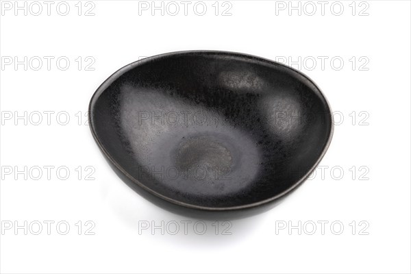 Empty black ceramic bowl isolated on white background. Side view, close up
