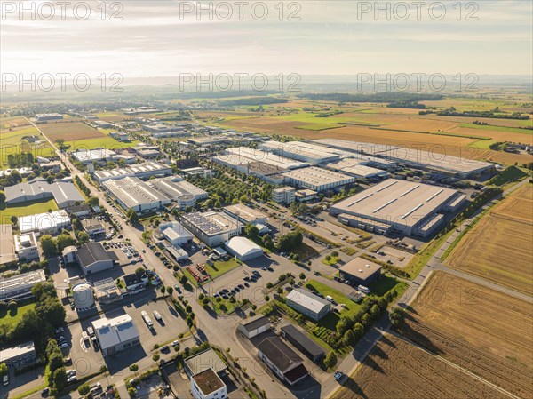 A large industrial area with factories, roads and surrounding fields in a rural area, taken from a bird's eye view, Wolfsberg industrial area, Nagold, Black Forest, Germany, Europe