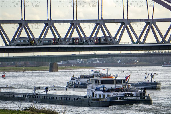 The Rhine near Düsseldorf, cargo ships, Hammer railway bridge, local train, North Rhine-Westphalia, Germany, Europe