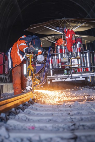 Worker welding a rail in a tunnel with flying sparks and large equipment, rail welding, track construction Hermann Hessebahn, Calw, Black Forest, Germany, Europe