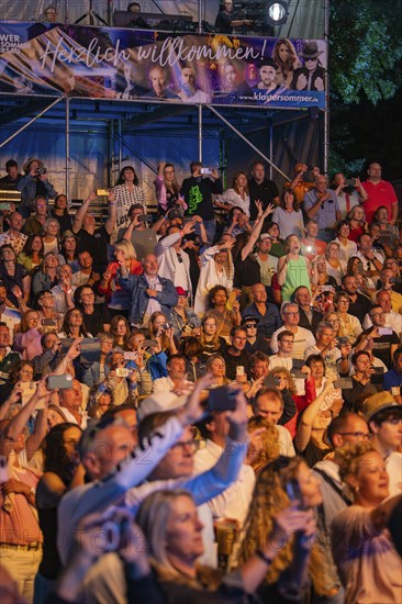 Crowd at night concert in front of stage with welcome banner, Klostersommer, Calw Hirsau, Black Forest, Germany, Europe