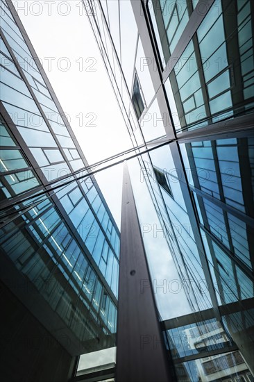 Mirrored modern glass buildings rise into the sky and reflect blue and clouds, University of Stuttgart, Germany, Europe