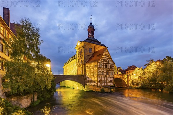 Old Town Hall on an artificial island in the River Regnitz. The landmark can be reached via two arched bridges. Night shot. City view of Bamberg, Upper Franconia, Bavaria, Germany, Europe