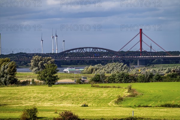 Rhine at Duisburg-Beeckerwerth, view across the Rhine meadows to the Haus Knipp railway bridge and the Beeckerwerth motorway bridge over the Rhine, A42, North Rhine-Westphalia, Germany, Europe