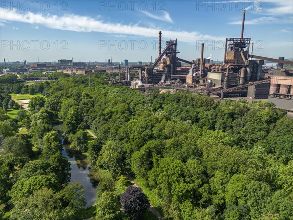 The Volkspark Schwelgern in Duisburg Marxloh, from 1925, municipal park donated by August Thyssen, directly adjacent to the high courtyards of the Thyssenkrupp Steel Marxloh steelworks, Duisburg, North Rhine-Westphalia, Germany, Europe