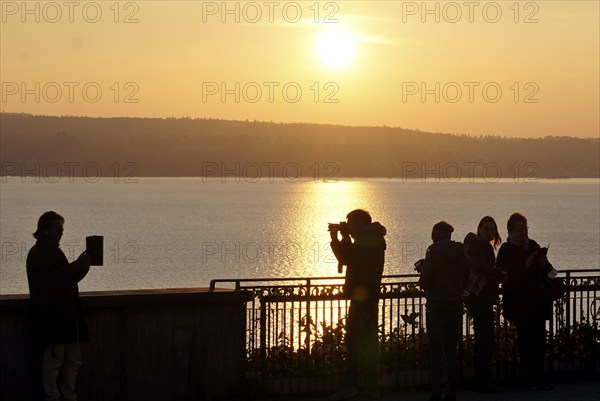 A man and a woman taking photos during sunset, Birnau, 10/10/2021