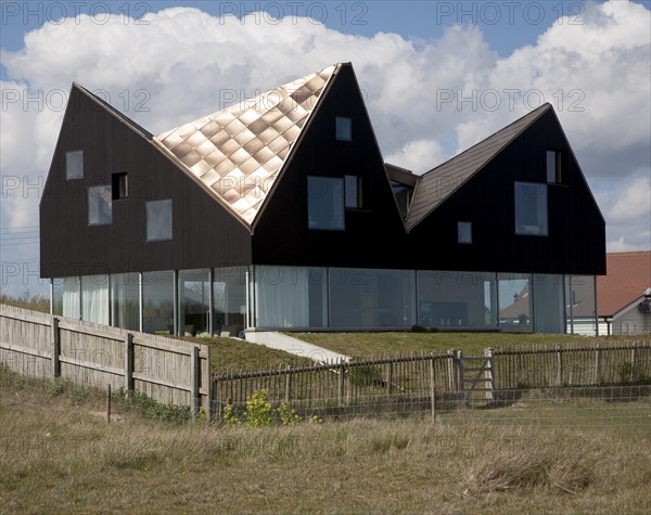 Sunshine shining on metal roof of modern house on the seafront at Thorpeness, Suffolk, England, United Kingdom, Europe