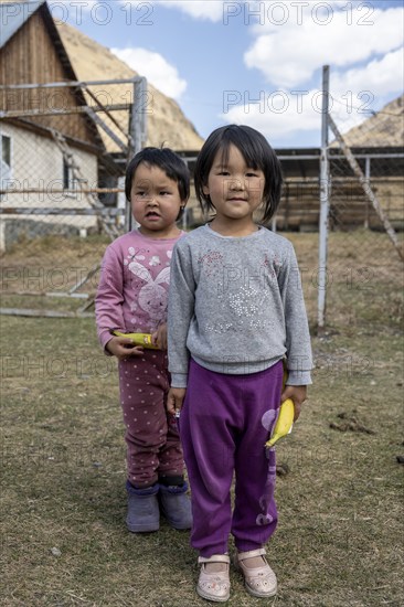 Two children in front of a farm, Issyk Kul province, Kyrgyzstan, Asia