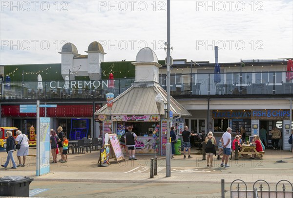 Holidaymakers around entrance to Claremont Pier, Lowestoft, Suffolk, England, UK