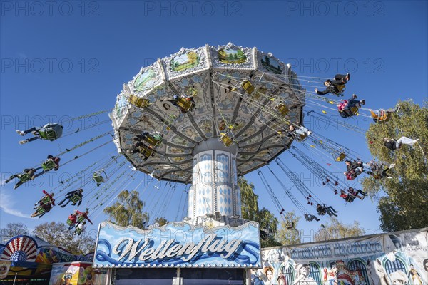 Wellenflug also known as Wellenflieger, a chain carousel constructed in Germany with hand-painted Bavarian motifs at the traditional Schätzelemarkt in Tengen, Hegau, district of Constance, Baden-Württemberg, Germany, Europe