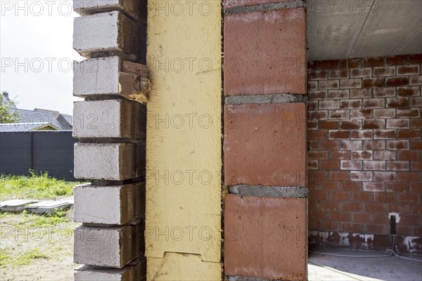 Close up of cavity wall insulation boards fitted in masonry cavities in newly built house used to reduce heat loss