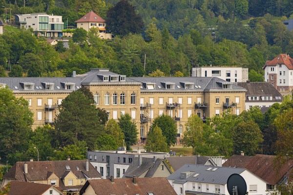 A view of a housing estate and historic buildings surrounded by green hills and forests, Nagold, Black Forest, Germany, Europe