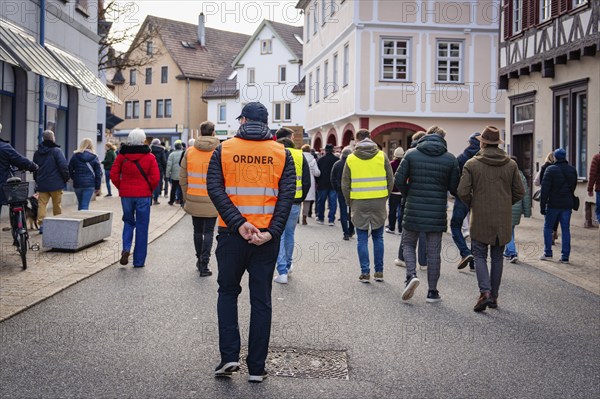 Rear view of an organiser walking through a city street, Gegen Rechts Demo, Nagold, Black Forest, Germany, Europe