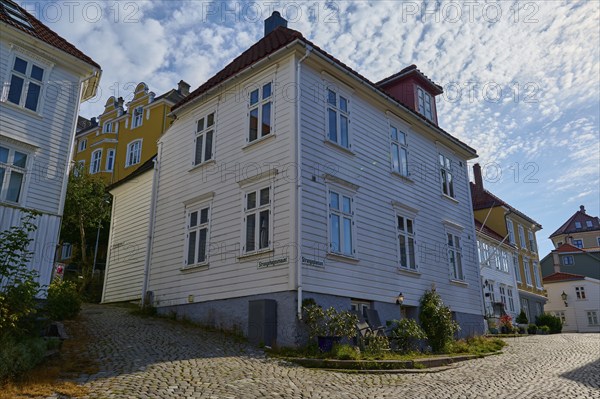 A quiet cobbled street in Bergen's old town centre, with traditional houses and sunny summer weather, Bergen, Vestland, Norway, Europe
