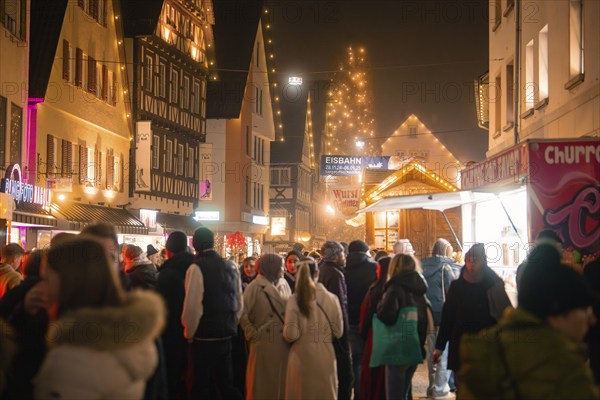 Full Christmas market at night with illuminated stalls and houses, surrounded by visitors, Lichternacht Fest, Nagold, Black Forest, Germany, Europe