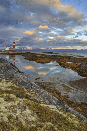 Lighthouse reflected in water, cloudy mood, mountains, coast, Tranoy, Ofoten, Norway, Europe