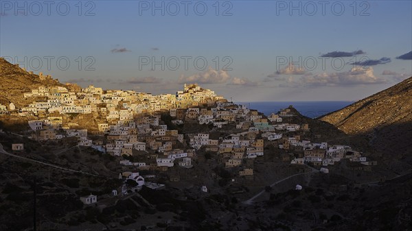 View of a hilltop town, illuminated by the morning sun, Colourful mountain village, Morning light, Olymbos, Karpathos, Dodecanese, Greek Islands, Greece, Europe