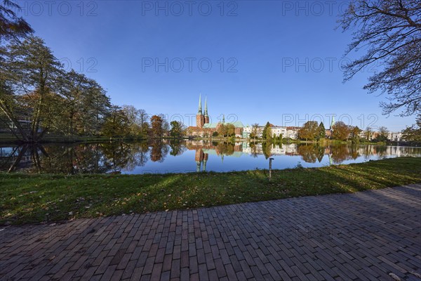 Long shot of the mill pond, park, trees, Lübeck Cathedral, symmetrical reflections on the water surface, Hanseatic city of Lübeck, Schleswig-Holstein, Germany, Europe