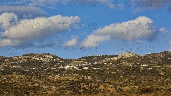 View of a hilly landscape with grassy hills under a blue sky with white clouds, West Coast, Karpathos, Dodecanese, Greek Islands, Greece, Europe