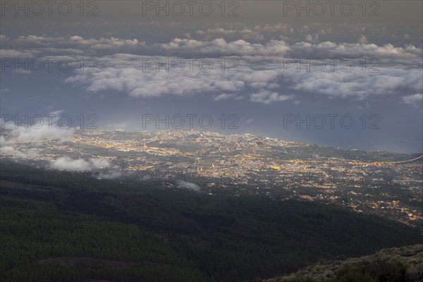 Night view from the Teide National Park, Parque Nacional del Teide, to the illuminated Orotava, Puerto de la Cruz and trade wind clouds over the Atlantic Ocean, Tenerife, Canary Islands, Spain, Europe